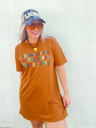 Woman wearing burnt orange oversized fall game day T-shirt dress with Hooray Sports graphic